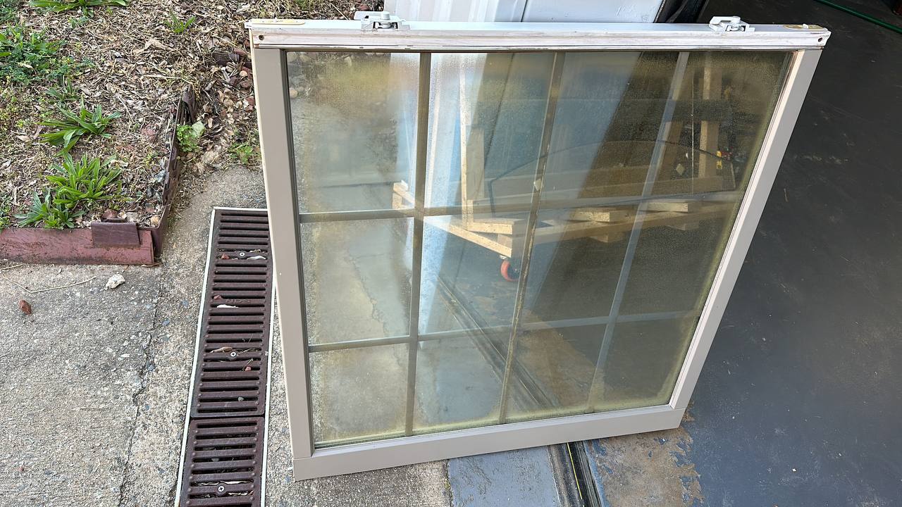 Foggy double-pane window showing seal failure with condensation between glass panes, demonstrating need for window repair