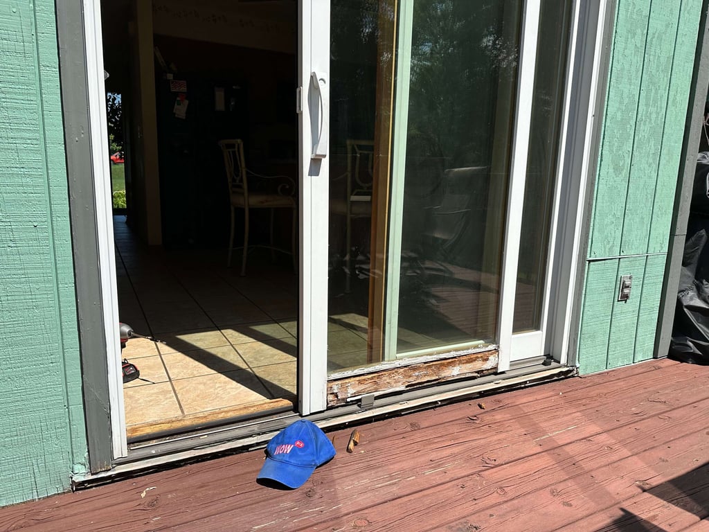 Damaged sliding glass door track showing wood rot and wear, requiring professional door repair services in Huntersville NC