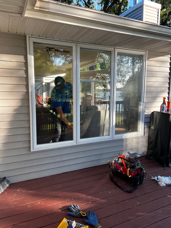 Professional window installation service in progress on residential home in Charlotte, showing tools and triple-pane window setup