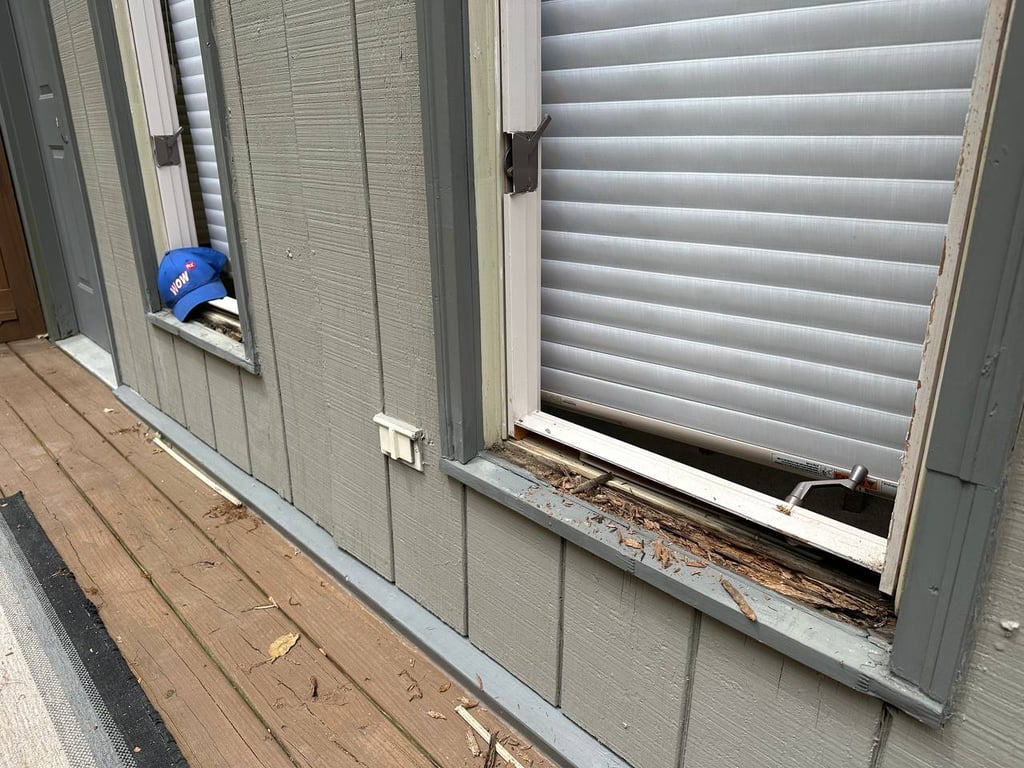 Deteriorating window frame with visible wood rot damage and worn siding, showcasing need for professional window repair services