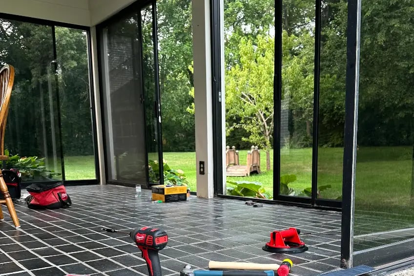 Skilled technicians repairing sliding glass doors for improved performance.