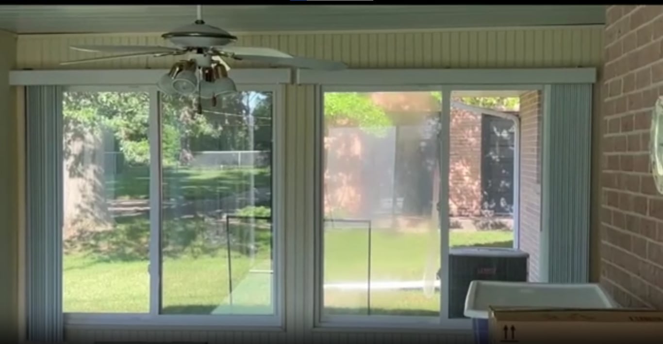 Sunroom with sliding glass doors and screens showing typical wear and tear, demonstrating need for professional screen repair in Charlotte