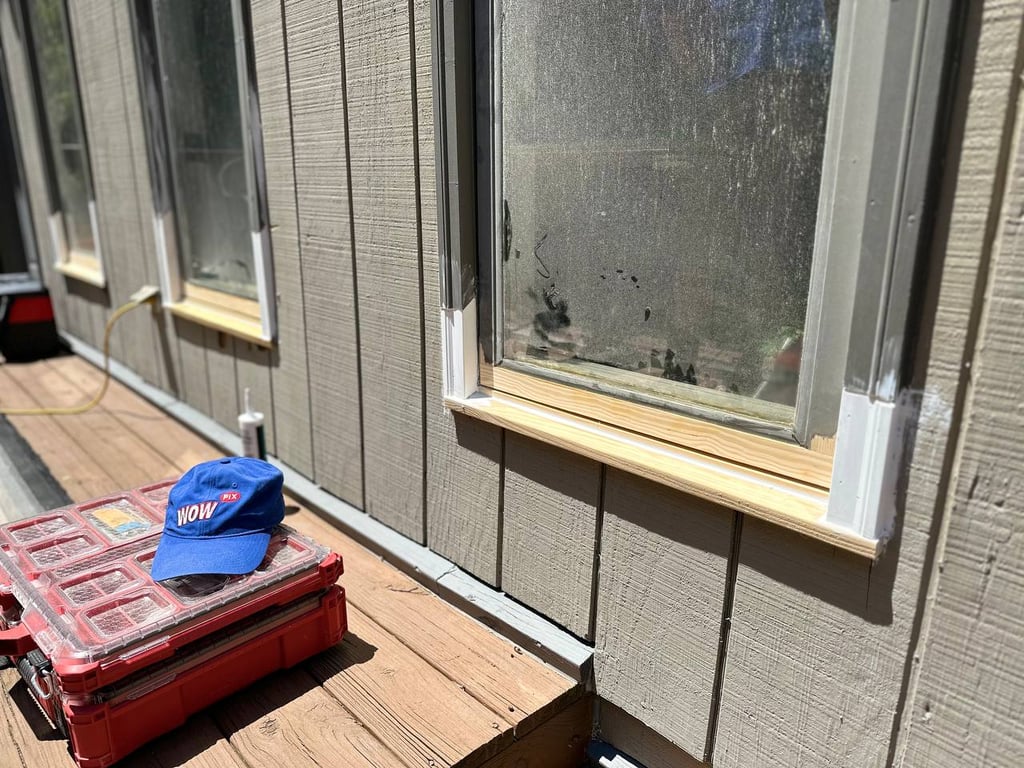 Window repair assessment showing moisture damage with WOW service cap and professional tools on wooden deck
